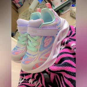 Little girls Sketchers shoes.